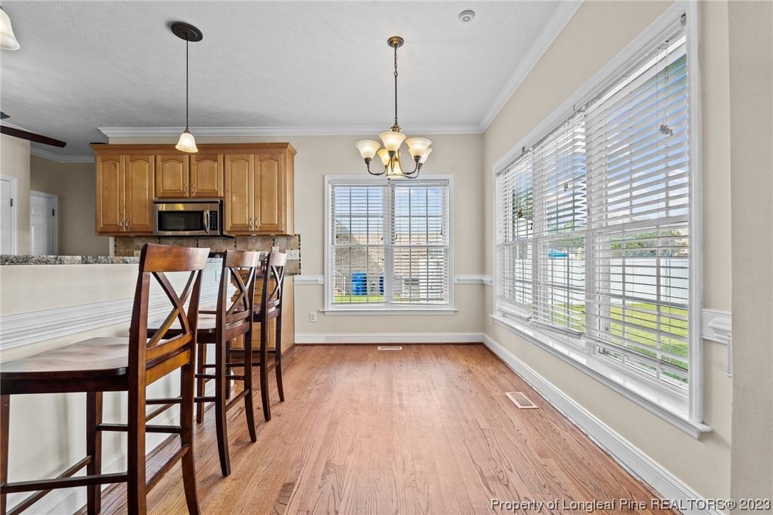 6407 Cattesmore Road Fayetteville, NC 28311 - Photo 14 of 42 a view of a dining room with furniture window and wooden floor