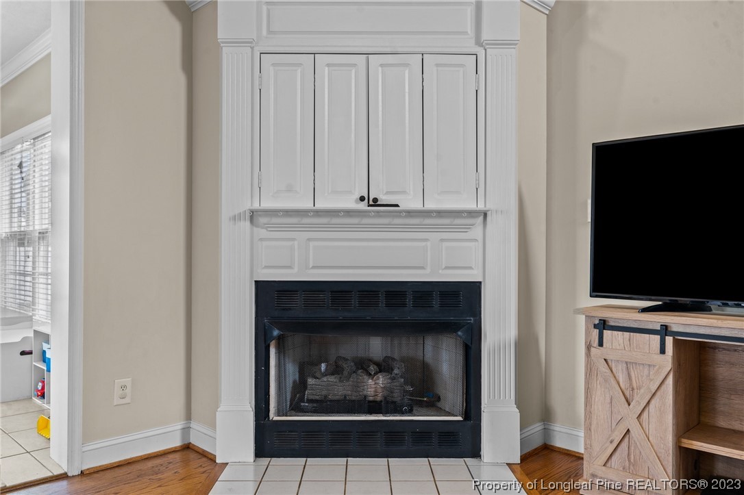 6407 Cattesmore Road Fayetteville, NC 28311 - Photo 15 of 42 a living room with furniture a fireplace and a flat screen tv