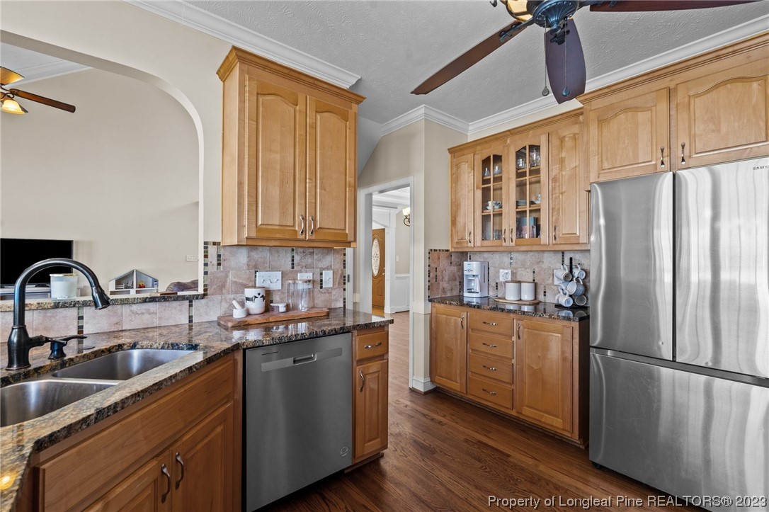 6407 Cattesmore Road Fayetteville, NC 28311 - Photo 19 of 42 a kitchen with stainless steel appliances granite countertop a refrigerator sink and cabinets