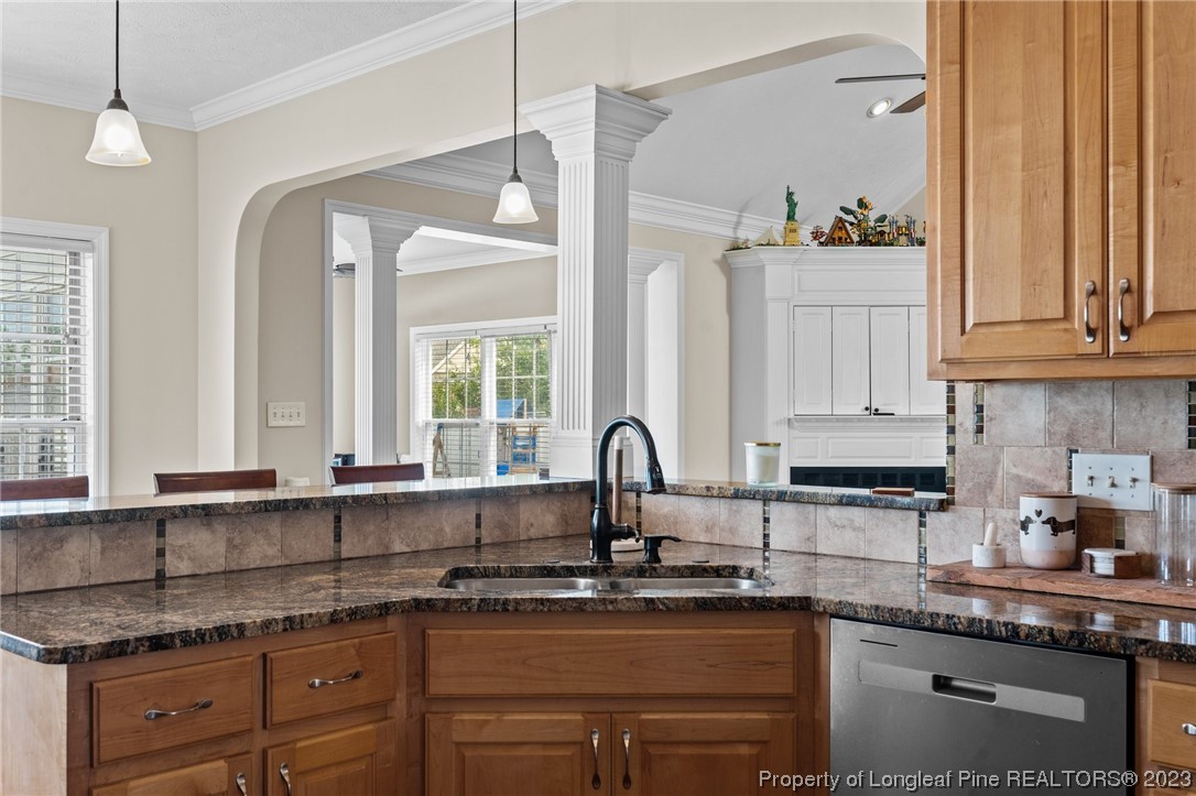 6407 Cattesmore Road Fayetteville, NC 28311 - Photo 20 of 42 a kitchen with granite countertop a sink stainless steel appliances white cabinets and a window