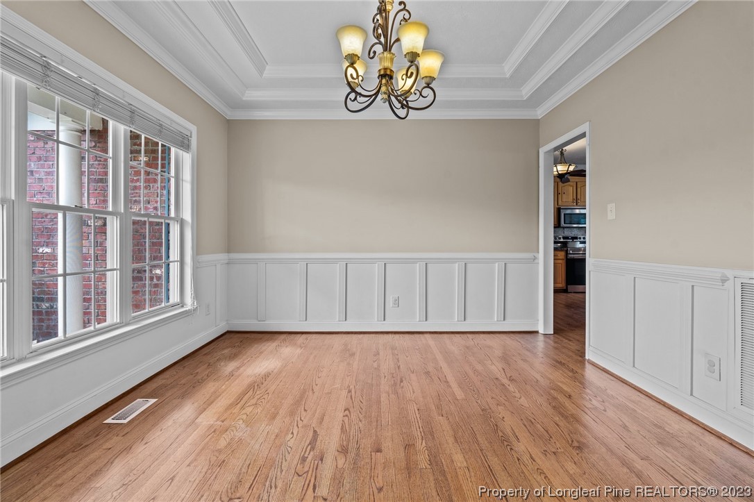 6407 Cattesmore Road Fayetteville, NC 28311 - Photo 23 of 42 a view of an empty room with wooden floor and a window