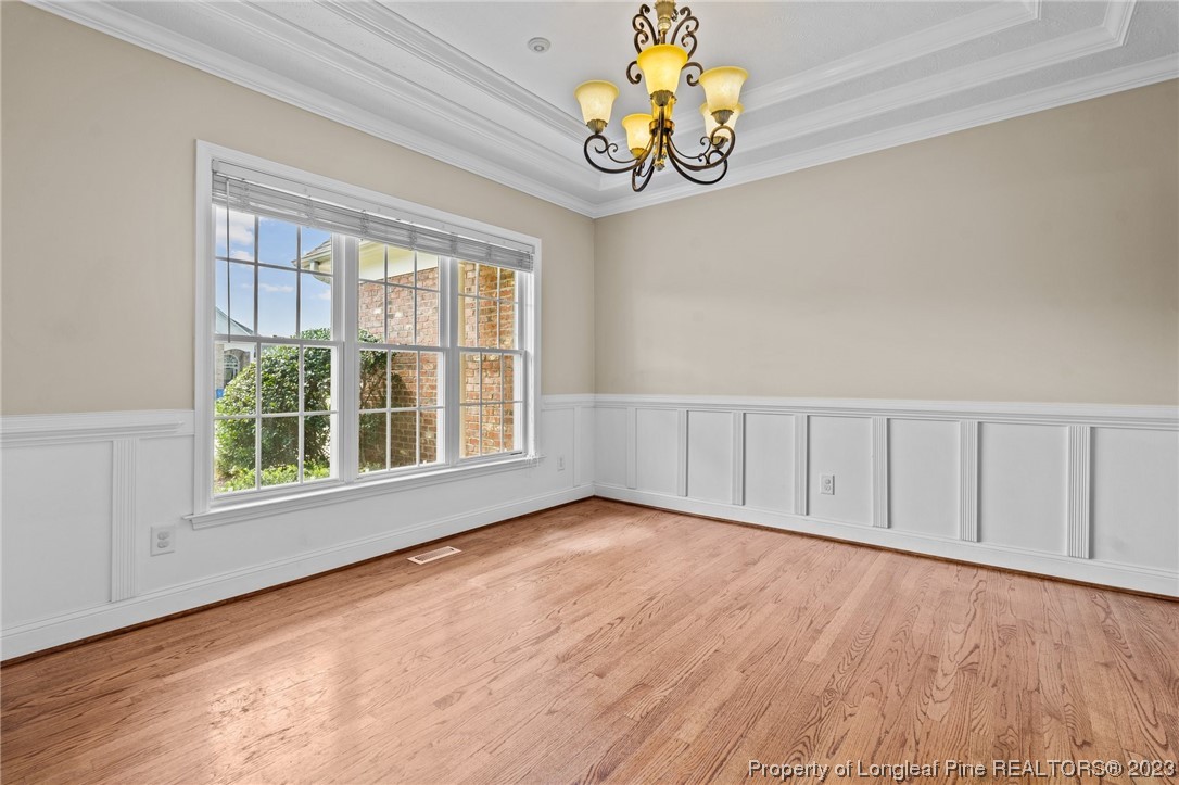 6407 Cattesmore Road Fayetteville, NC 28311 - Photo 24 of 42 a view of an empty room with a window and wooden floor