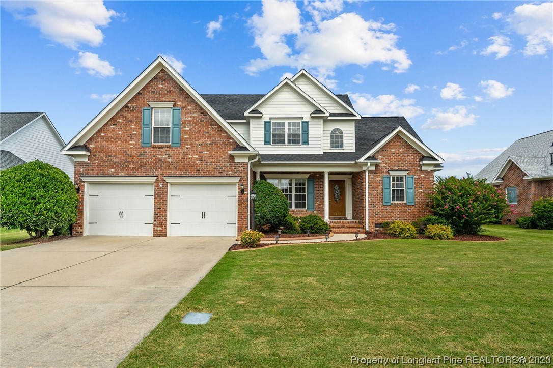 6407 Cattesmore Road Fayetteville, NC 28311 - Photo 32 of 42 a front view of a house with a yard and garage