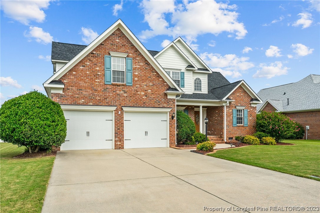 6407 Cattesmore Road Fayetteville, NC 28311 - Photo 33 of 42 a front view of a house with a yard and garage