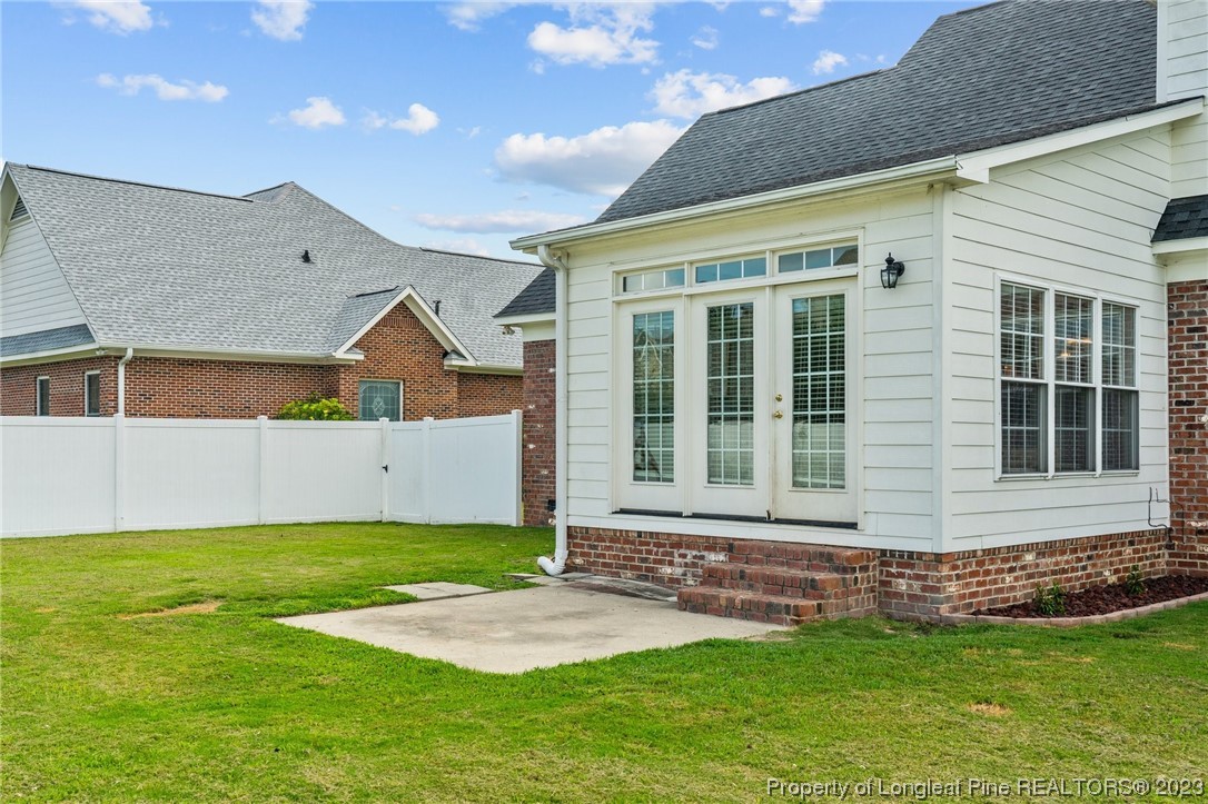 6407 Cattesmore Road Fayetteville, NC 28311 - Photo 40 of 42 a front view of a house with a yard and garage