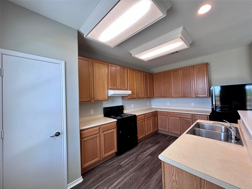 8916 Ipswich Bay Drive Austin, TX 78747 - Photo 11 of 39 a kitchen with a sink a stove and cabinets