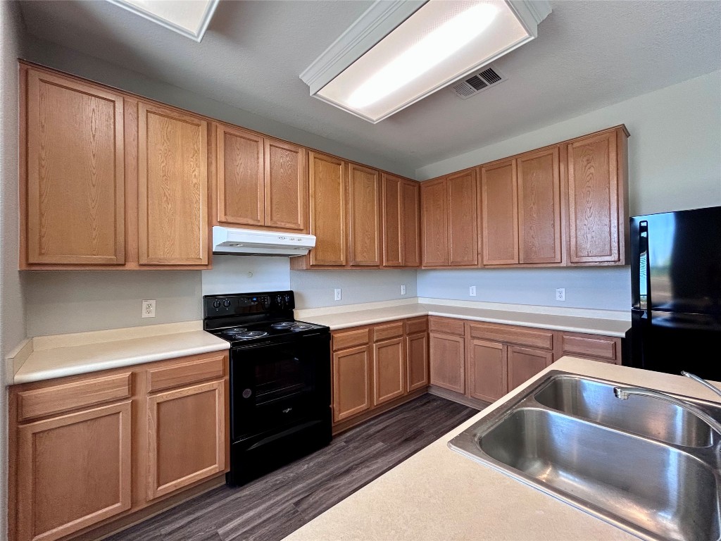 8916 Ipswich Bay Drive Austin, TX 78747 - Photo 12 of 39 a kitchen with granite countertop a sink stainless steel appliances and cabinets