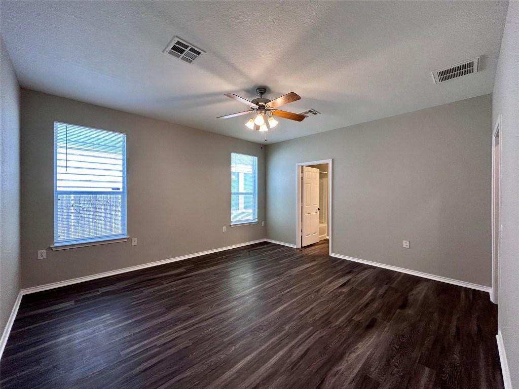 8916 Ipswich Bay Drive Austin, TX 78747 - Photo 15 of 39 a view of an empty room with window and wooden floor
