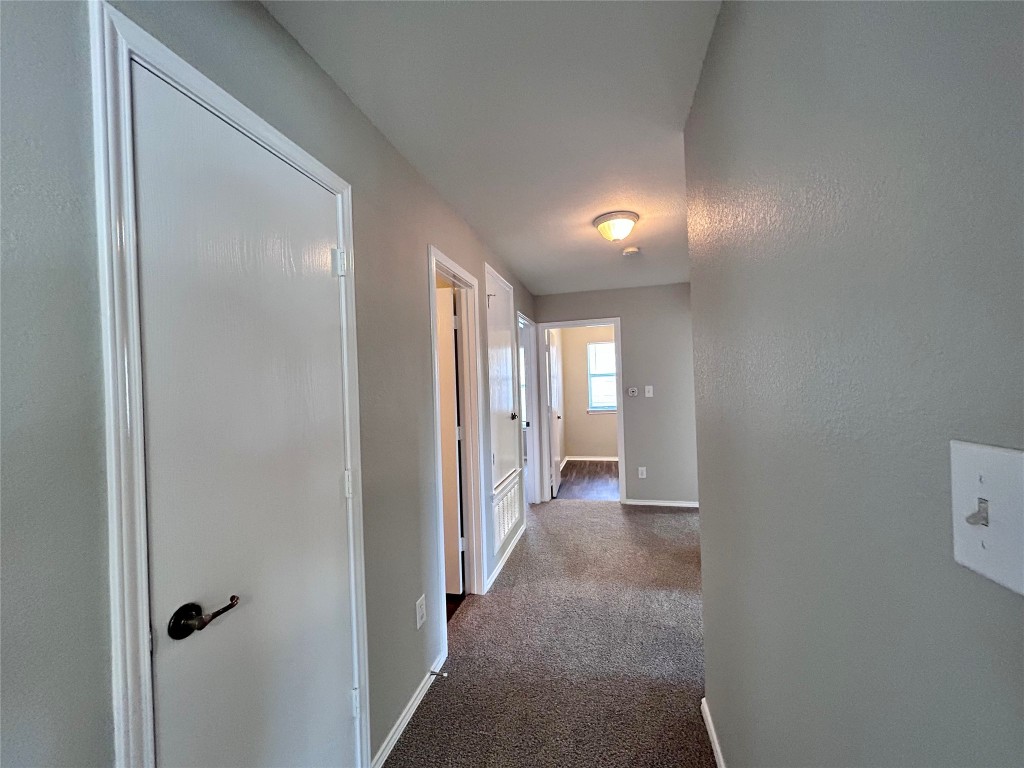 8916 Ipswich Bay Drive Austin, TX 78747 - Photo 25 of 39 a view of a hallway with wooden shelves