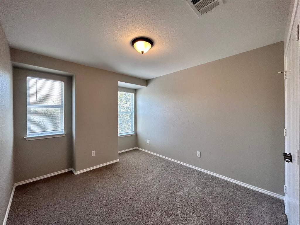 8916 Ipswich Bay Drive Austin, TX 78747 - Photo 26 of 39 an empty room with windows and closet