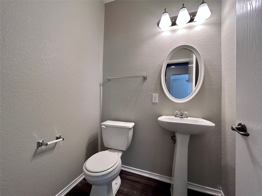 8916 Ipswich Bay Drive Austin, TX 78747 - Photo 6 of 39 a bathroom with a toilet sink and mirror