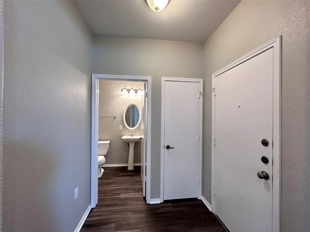8916 Ipswich Bay Drive Austin, TX 78747 - Photo 7 of 39 a view of a hallway with wooden floor
