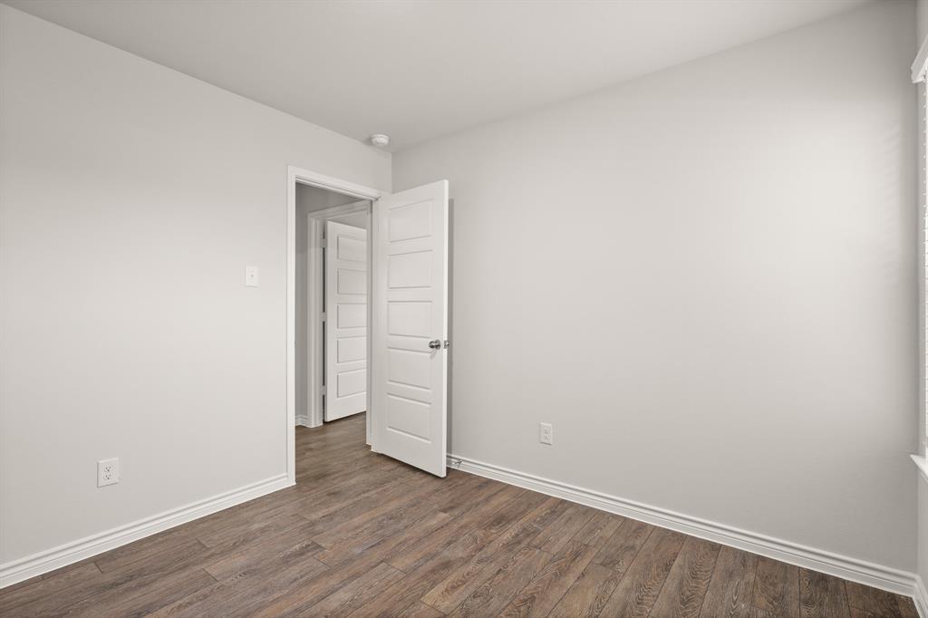 1508 Romans Road Ennis, TX 75119 - Photo 12 of 19 a view of an empty room with wooden floor