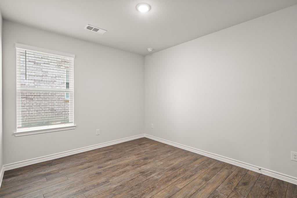 1508 Romans Road Ennis, TX 75119 - Photo 13 of 19 wooden floor in an empty room with a window
