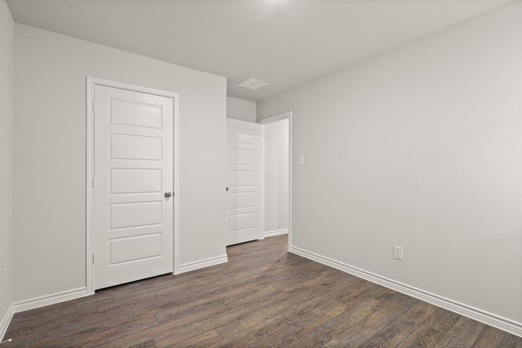 1508 Romans Road Ennis, TX 75119 - Photo 14 of 19 a view of an empty room with wooden floor