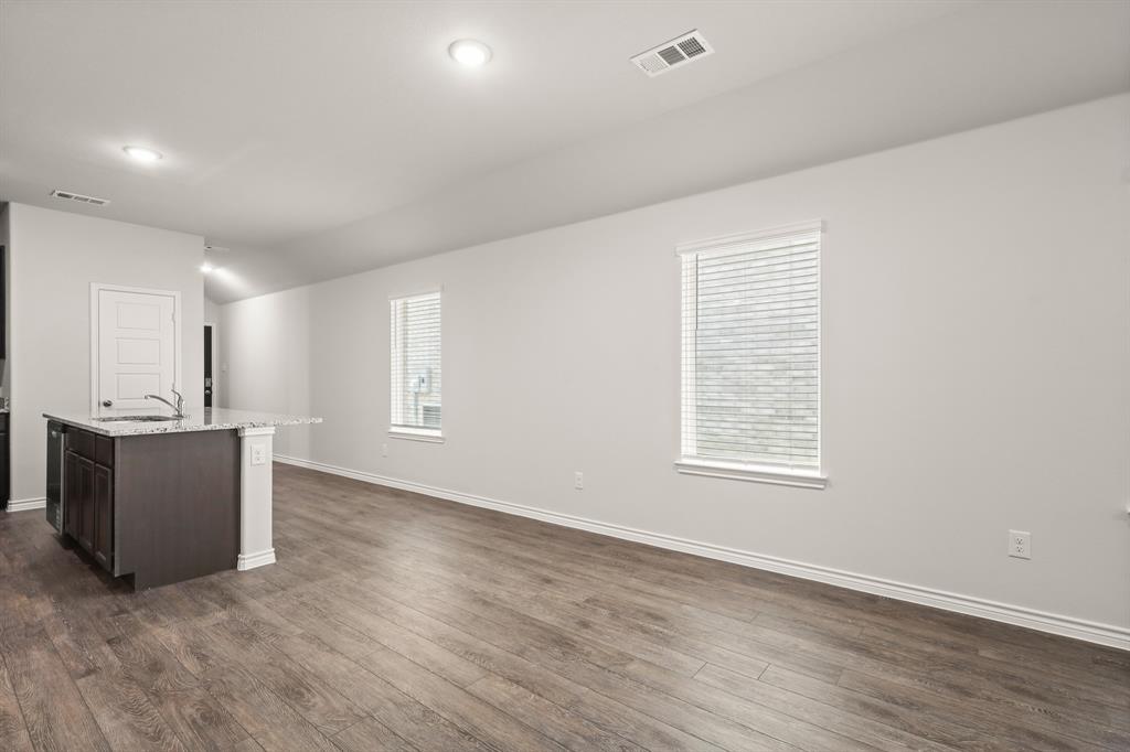 1508 Romans Road Ennis, TX 75119 - Photo 5 of 19 an empty room with wooden floor and windows