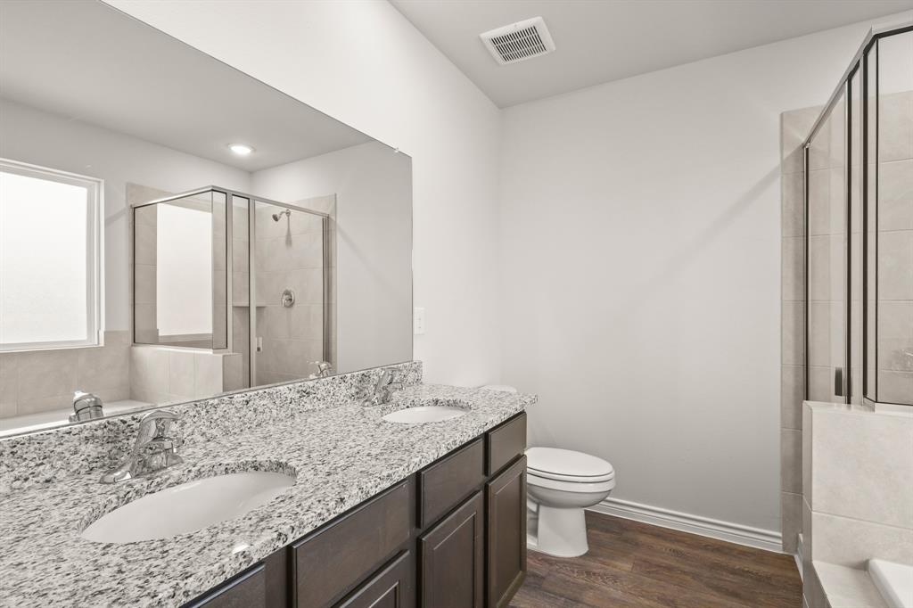 1508 Romans Road Ennis, TX 75119 - Photo 10 of 19 a bathroom with a granite countertop sink toilet and shower