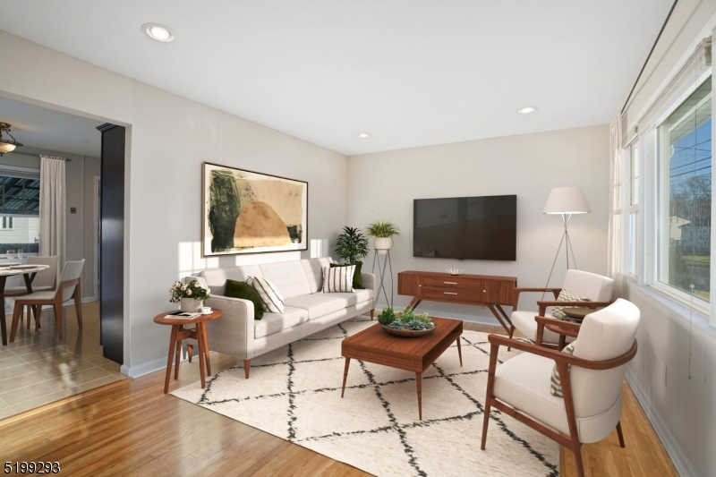 8 Corsi Road Bloomfield, NJ 07003 - Photo 3 of 11 a living room with furniture a flat screen tv and a large window