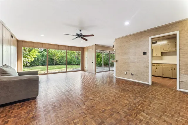 a view of a livingroom with a ceiling fan and window