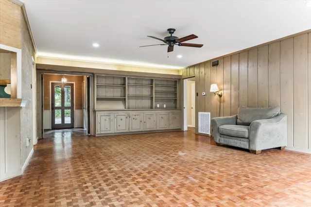 a view of an empty room with a ceiling fan