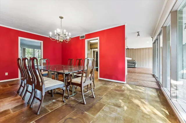 a view of a dining room with furniture and chandelier