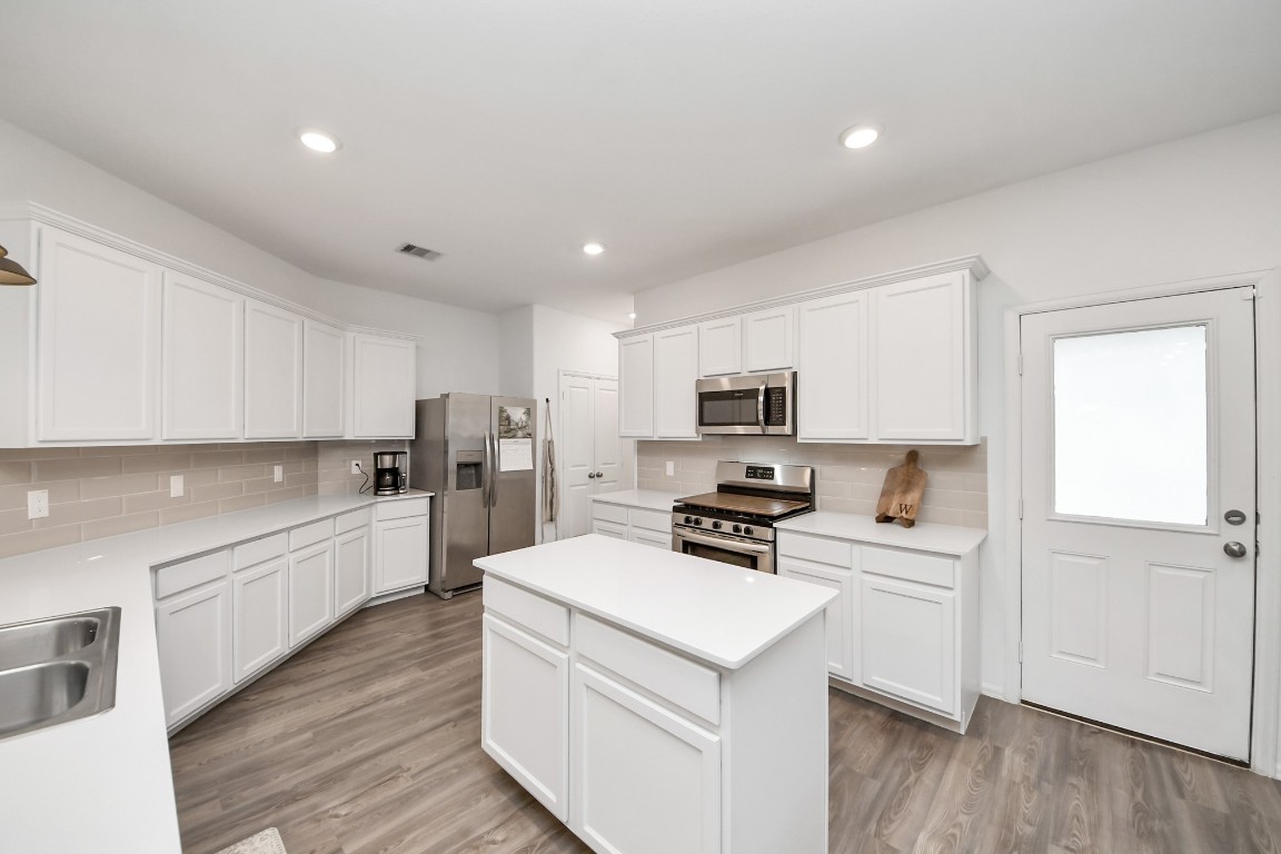 2835 Mistygate Court Conroe, TX 77301 - Photo 11 of 35 Bright, modern kitchen with generous counter space, stainless steel appliances, and a functional layout.