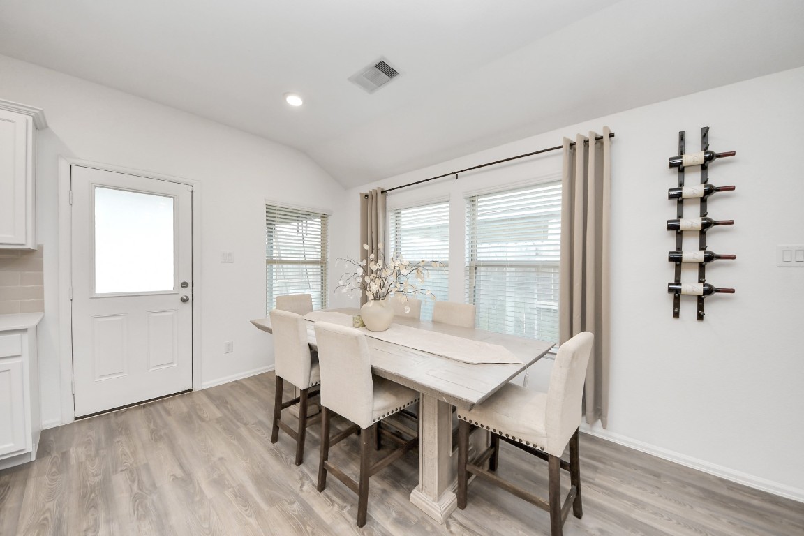 2835 Mistygate Court Conroe, TX 77301 - Photo 14 of 35 Light-filled dining space surrounded by windows, designed for both everyday living and entertaining.