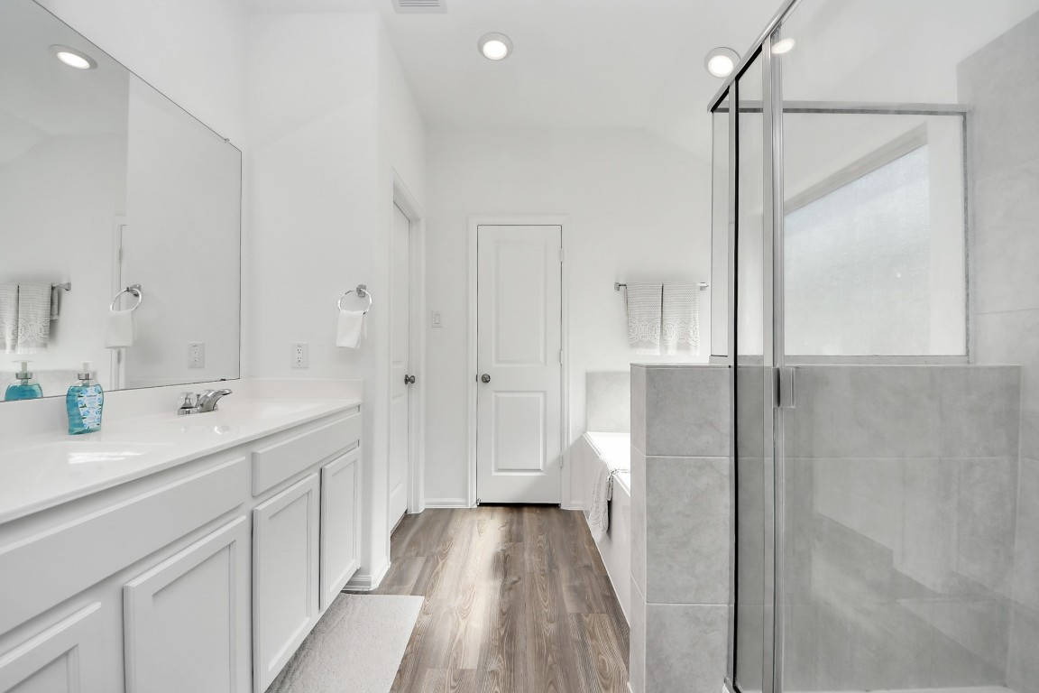 2835 Mistygate Court Conroe, TX 77301 - Photo 17 of 35 Bright primary bathroom featuring dual sinks, ample counter space, and a walk-in shower.