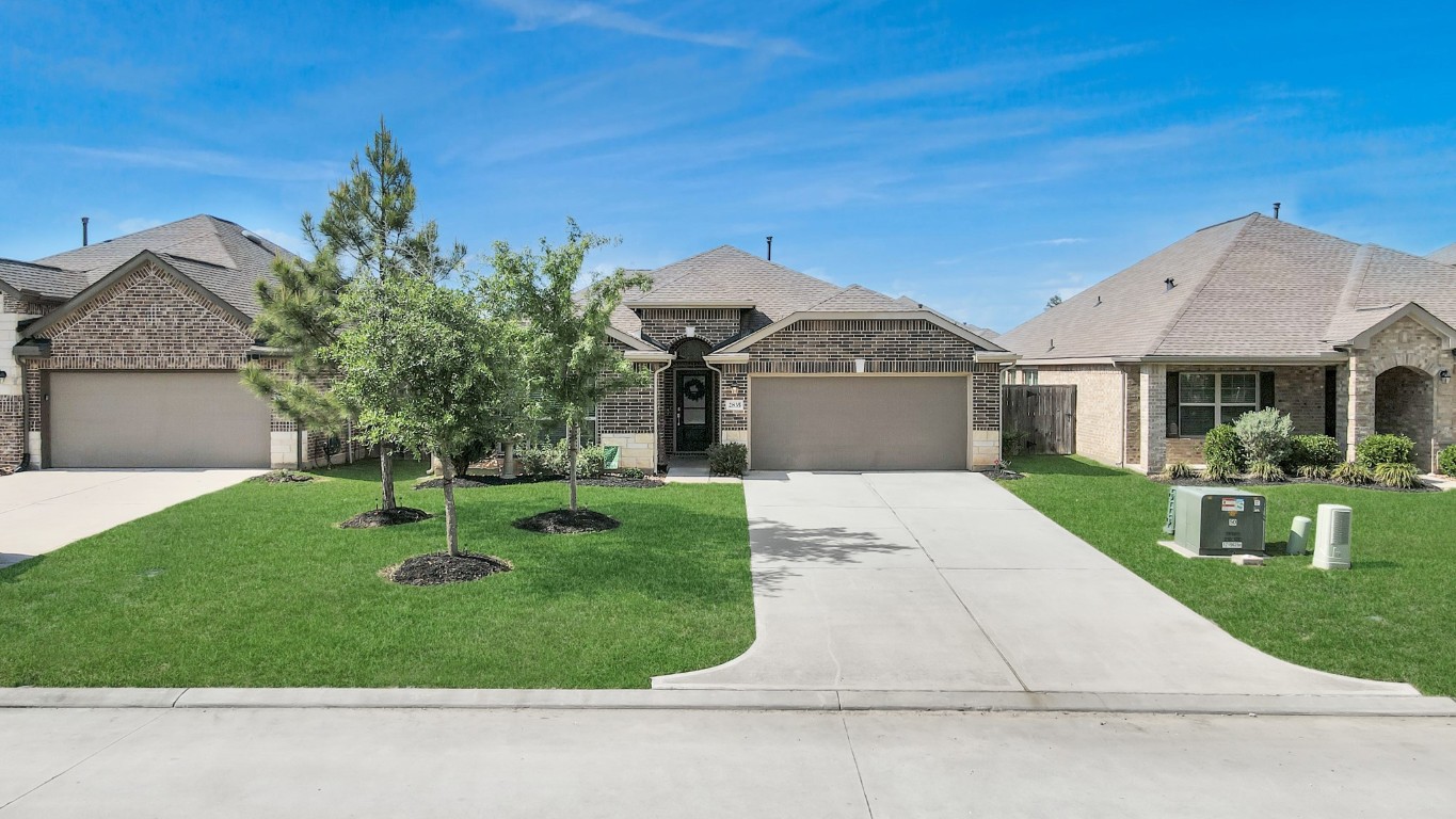 2835 Mistygate Court Conroe, TX 77301 - Photo 2 of 35 Spacious front yard with mature landscaping and a wide driveway offering both curb appeal and everyday convenience