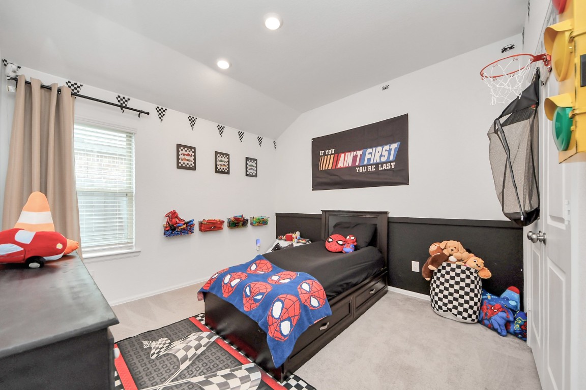 2835 Mistygate Court Conroe, TX 77301 - Photo 22 of 35 Secondary bedroom with a spacious layout and natural light - perfect for guests, family, or a personalized space.