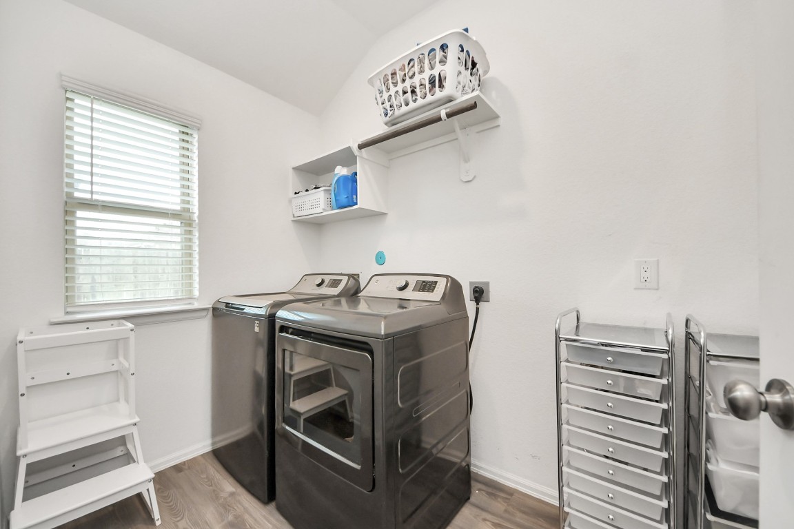 2835 Mistygate Court Conroe, TX 77301 - Photo 28 of 35 Dedicated laundry room with room for full-size washer and dryer and added shelving for extra storage.