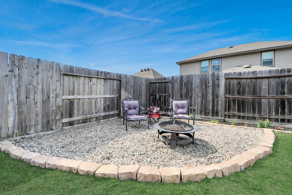 2835 Mistygate Court Conroe, TX 77301 - Photo 30 of 35 Cozy outdoor seating area with fire pit is ideal for evenings under the Texas sky.