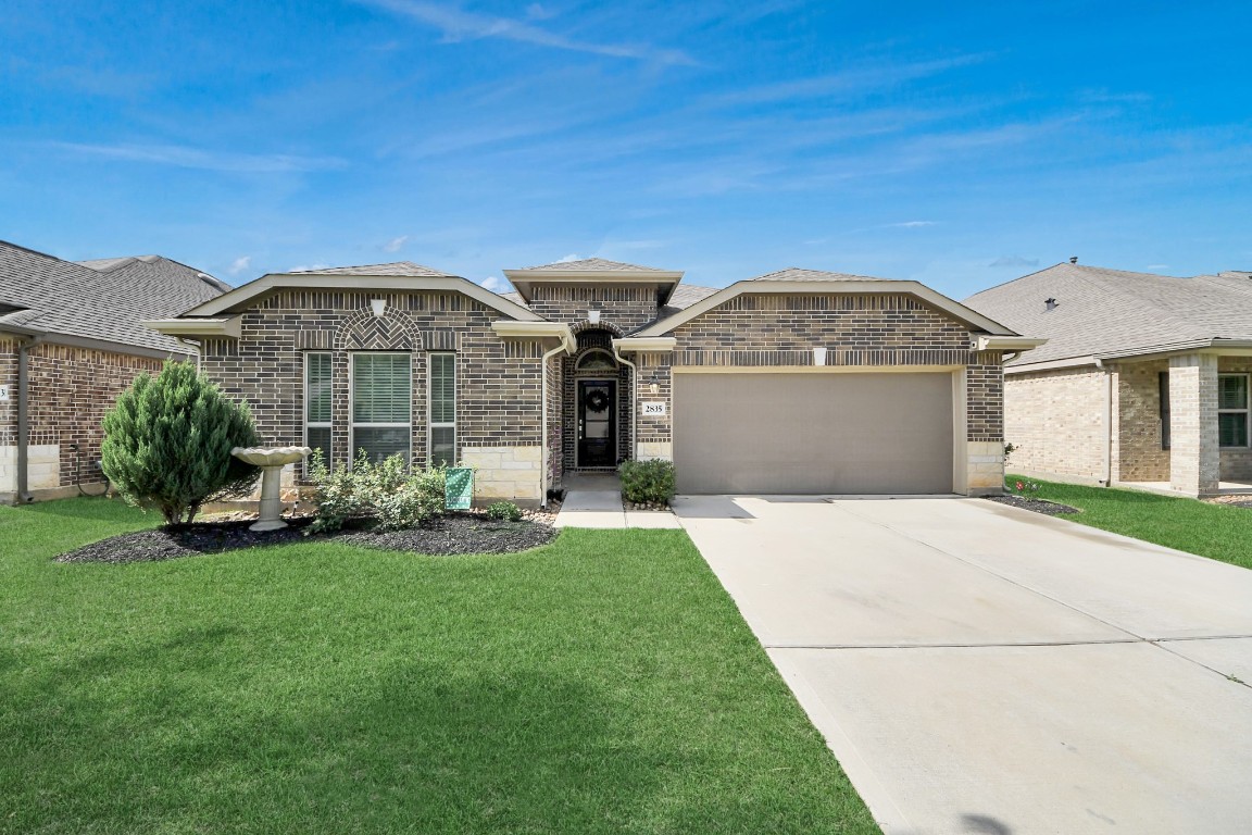 2835 Mistygate Court Conroe, TX 77301 - Photo 34 of 35 Classic brick exterior paired with clean landscaping delivers timeless curb appeal.