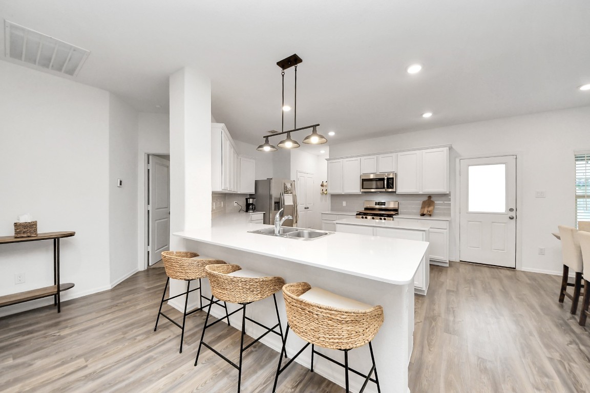 2835 Mistygate Court Conroe, TX 77301 - Photo 10 of 35 Spacious kitchen featuring an expansive island, abundant cabinetry, and an open layout designed for everyday living.