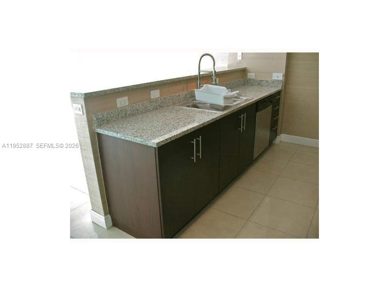 2694 Inagua Avenue, Unit 303 Coconut Grove, FL 33133 - Photo 12 of 18 a kitchen with a sink and cabinets