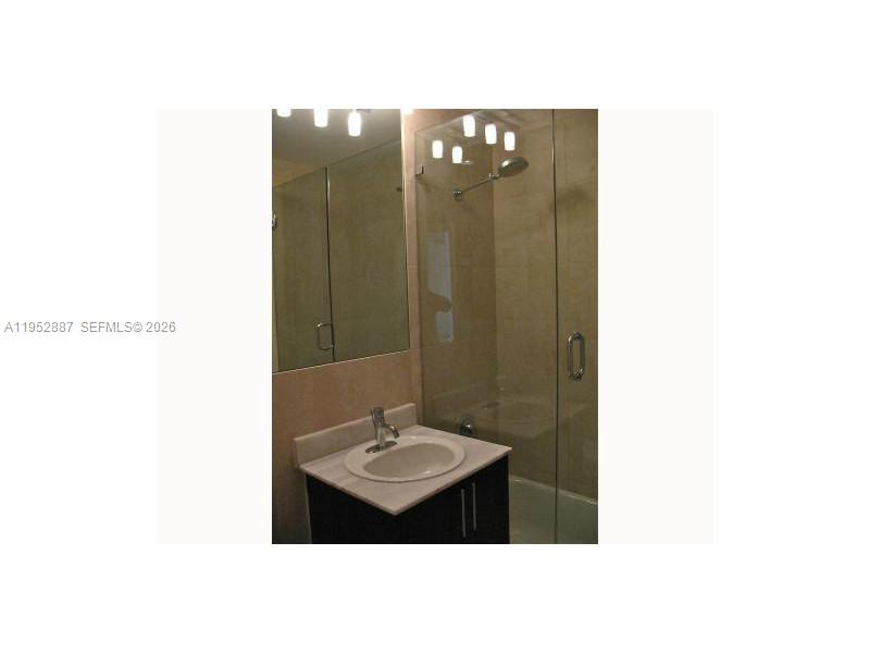2694 Inagua Avenue, Unit 303 Coconut Grove, FL 33133 - Photo 13 of 18 a bathroom with a sink shower and a mirror