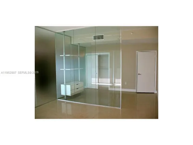 a bathroom with a sink shower and a mirror