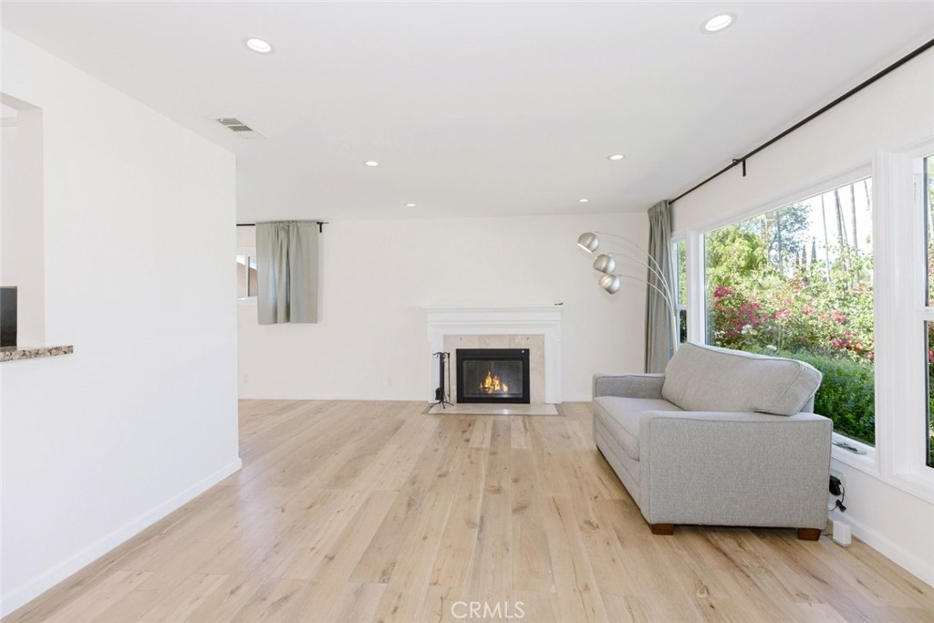 17134 Sherman Way Lake Balboa, CA 91406 - Photo 11 of 27 a living room with furniture and a fireplace