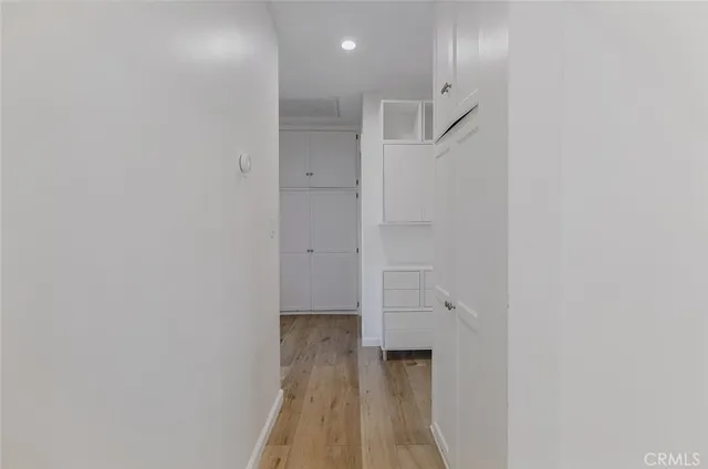 a view of a hallway with wooden floor
