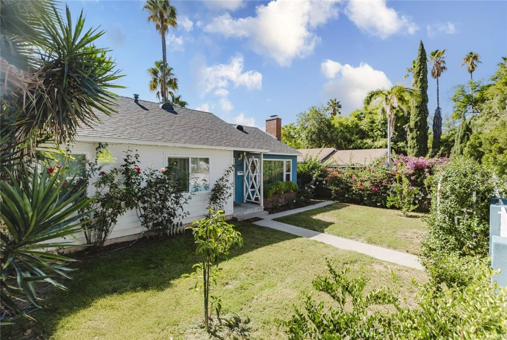 17134 Sherman Way Lake Balboa, CA 91406 - Photo 2 of 27 a front view of a house with garden