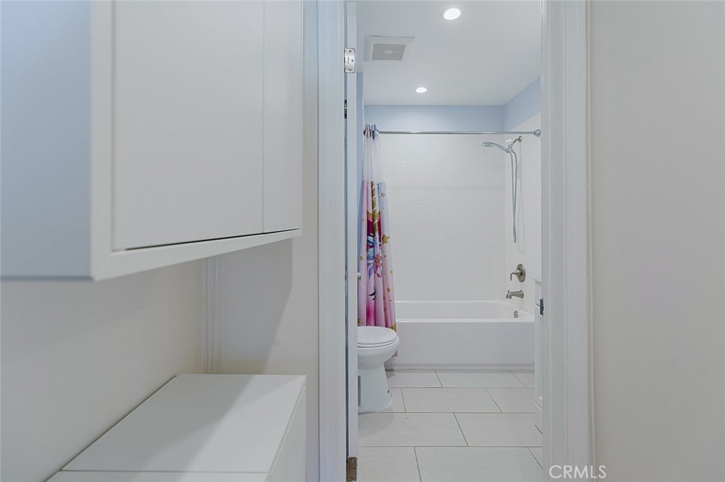 17134 Sherman Way Lake Balboa, CA 91406 - Photo 21 of 27 a bathroom with a bathtub and a shower