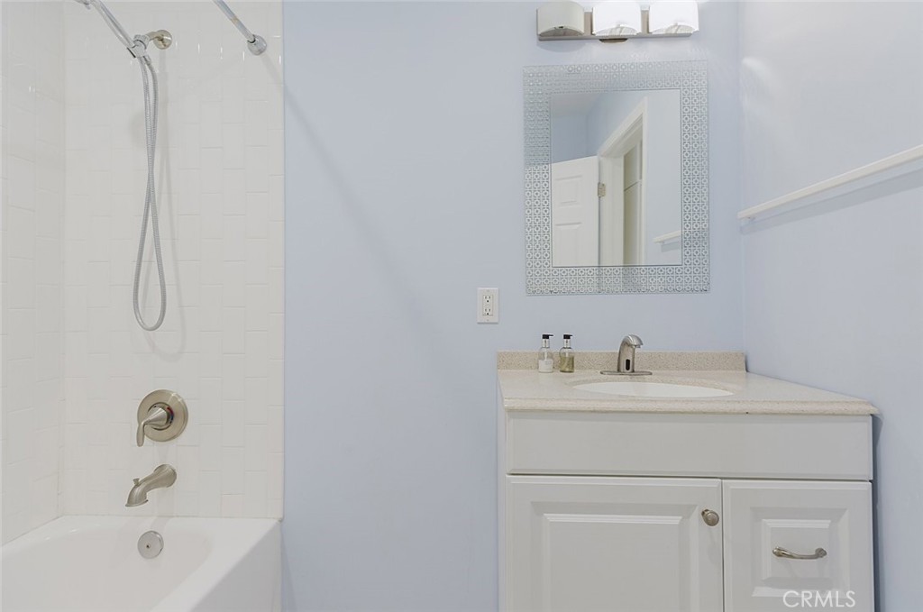 17134 Sherman Way Lake Balboa, CA 91406 - Photo 23 of 27 a bathroom with a sink a vanity and a bathtub