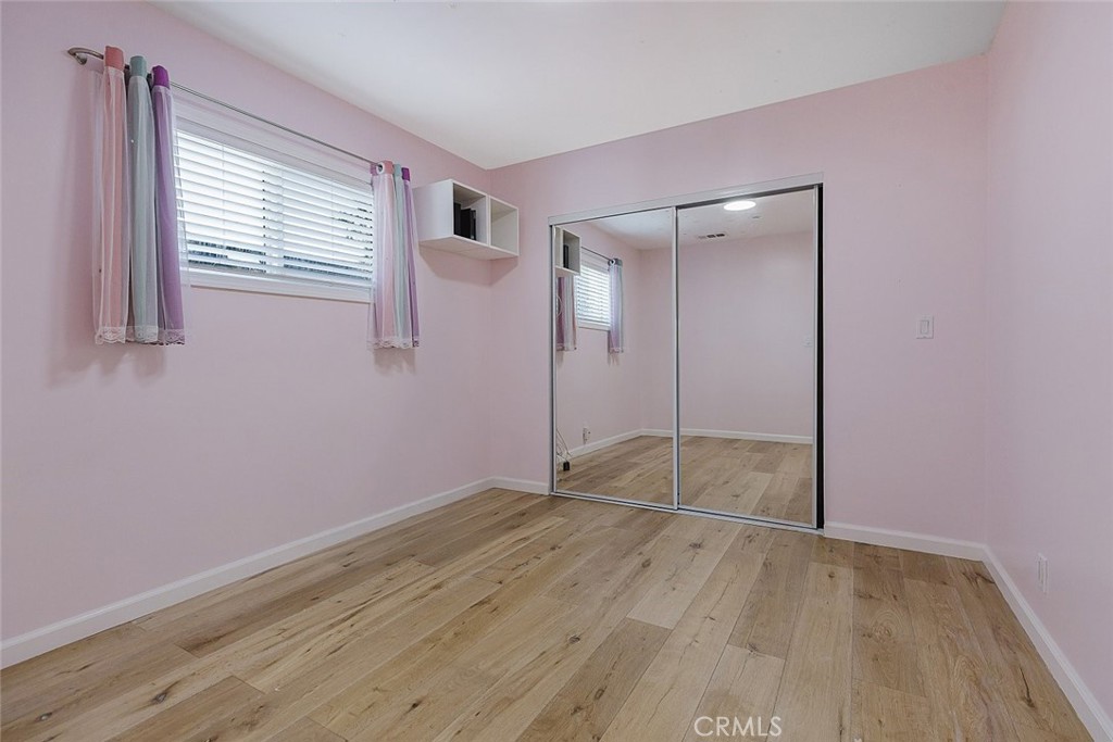 17134 Sherman Way Lake Balboa, CA 91406 - Photo 24 of 27 an empty room with wooden floor and windows