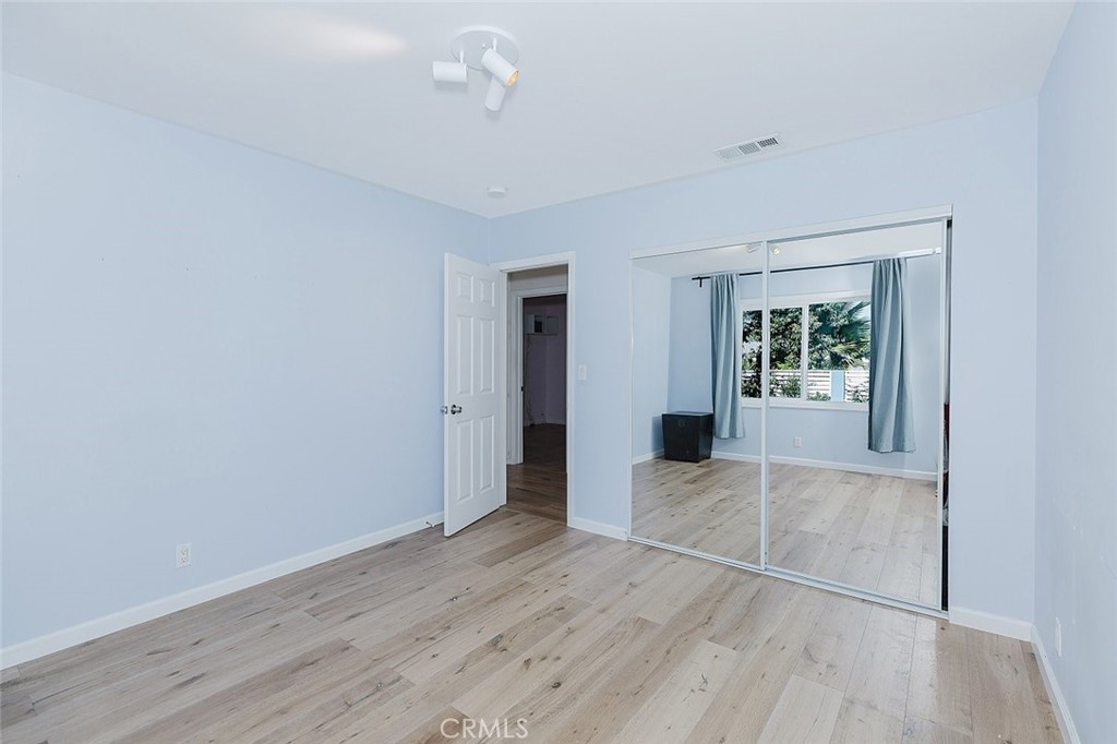 17134 Sherman Way Lake Balboa, CA 91406 - Photo 27 of 27 an empty room with wooden floor and windows