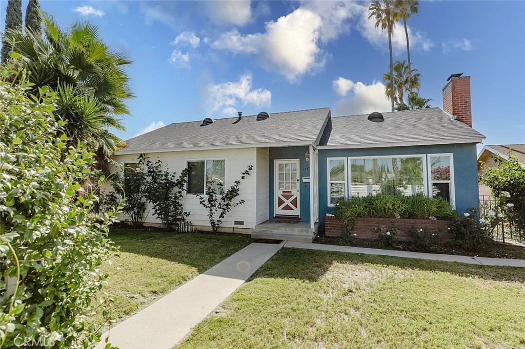 17134 Sherman Way Lake Balboa, CA 91406 - Photo 3 of 27 a front view of a house with garden