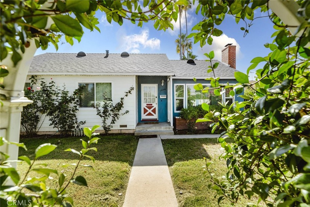 17134 Sherman Way Lake Balboa, CA 91406 - Photo 4 of 27 a front view of a house with garden