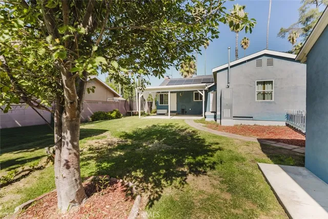 a backyard of a house with yard and outdoor seating