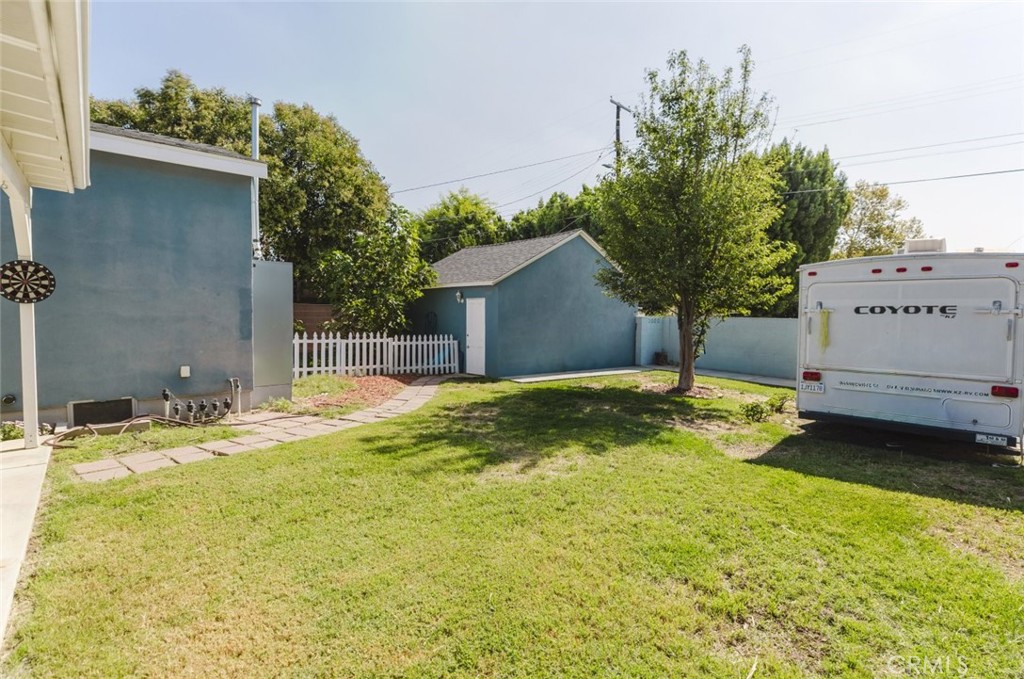 17134 Sherman Way Lake Balboa, CA 91406 - Photo 7 of 27 a swimming pool with yard and outdoor seating