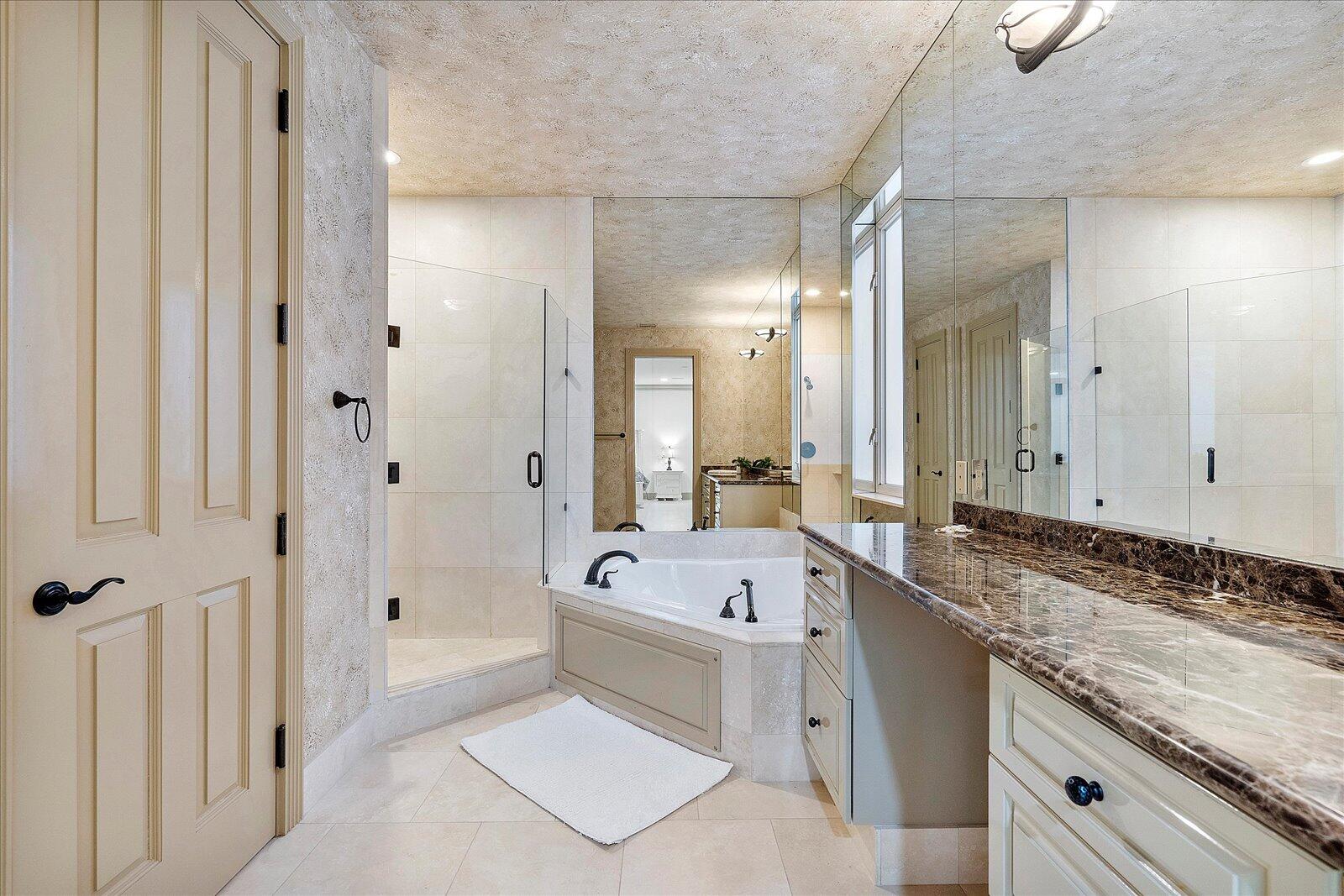 414 Riviera Isle Drive Fort Lauderdale, FL 33301 - Photo 38 of 70 a bathroom with a tub sink and mirror