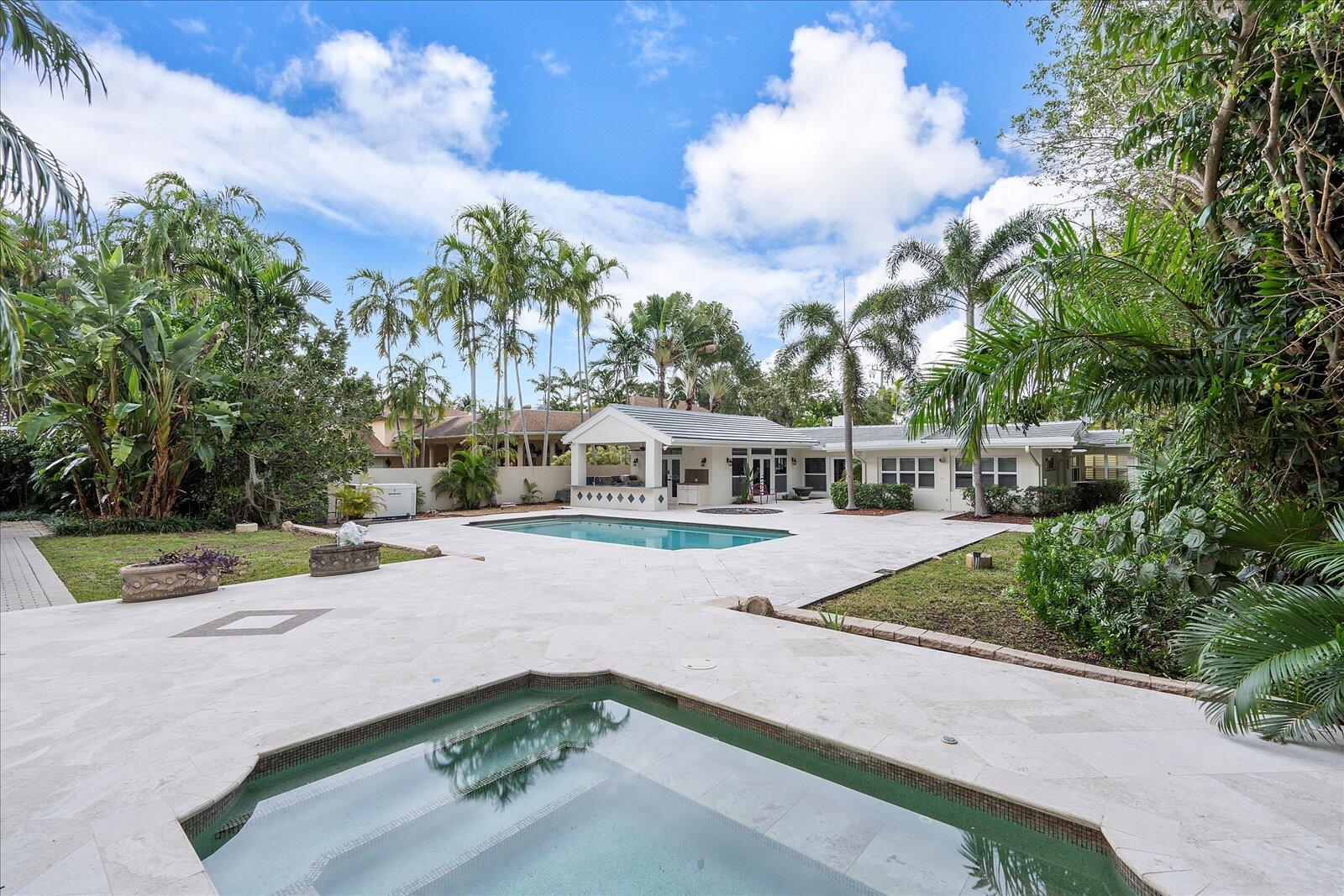 414 Riviera Isle Drive Fort Lauderdale, FL 33301 - Photo 45 of 70 a view of a swimming pool with an outdoor seating and a forest